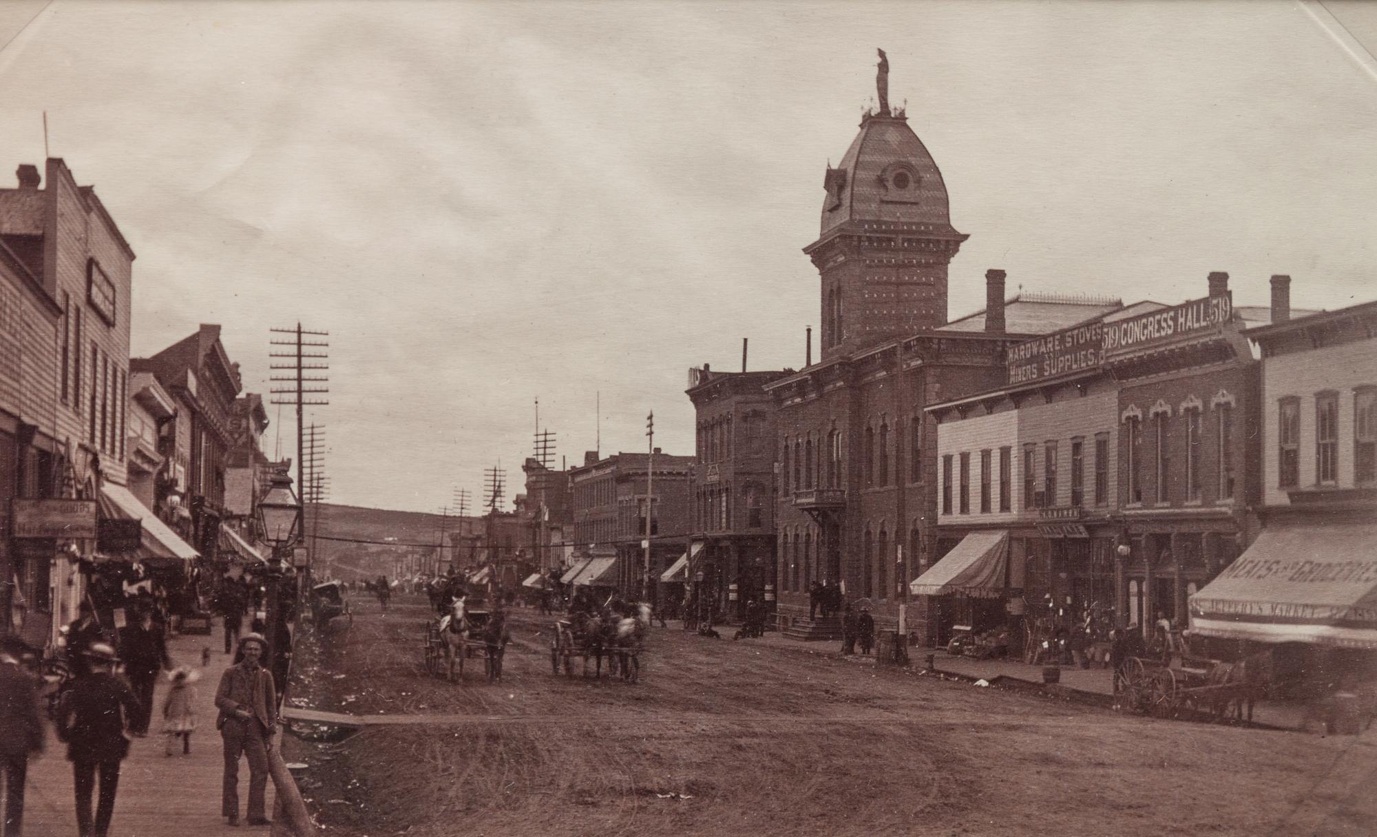 A group of three photographs (3647. Miners at Home; Untitled (main street); 2209. Dug Out - Bluer River Valley)
