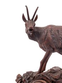 A Black Forest Carved Clock Garniture