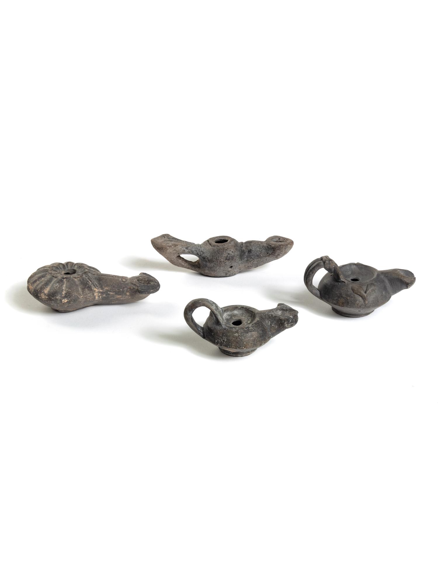 Four Roman Molded Terra Cotta Oil Lamps