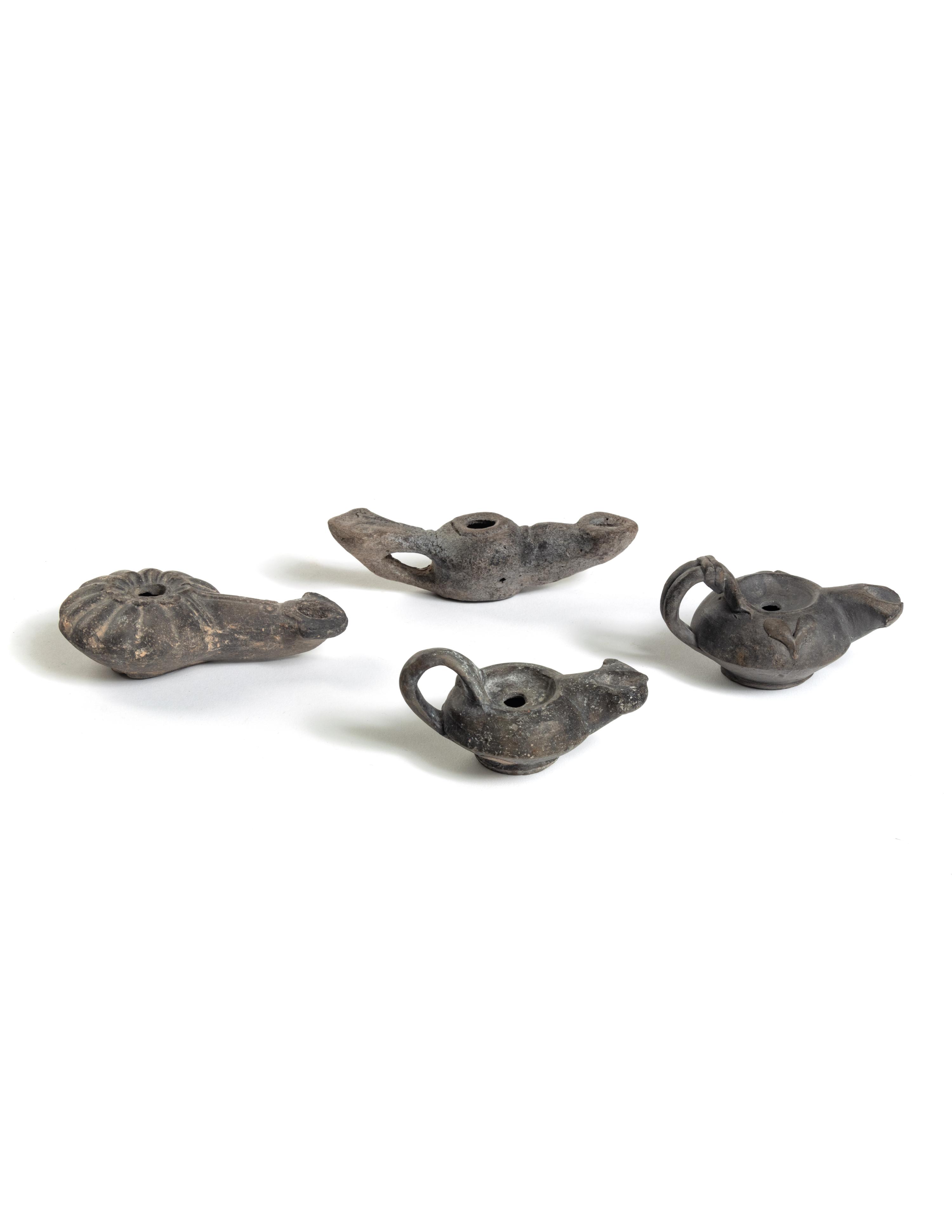 Four Roman Molded Terra Cotta Oil Lamps