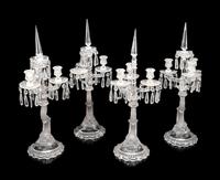 A Set of Four Baccarat Dauphin Three-Light Candelabra