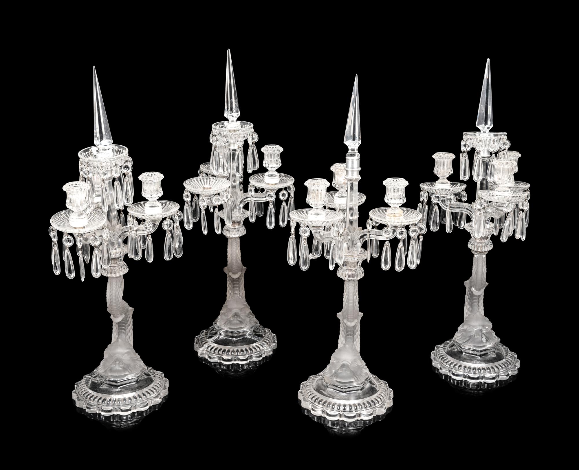 A Set of Four Baccarat Dauphin Three-Light Candelabra
