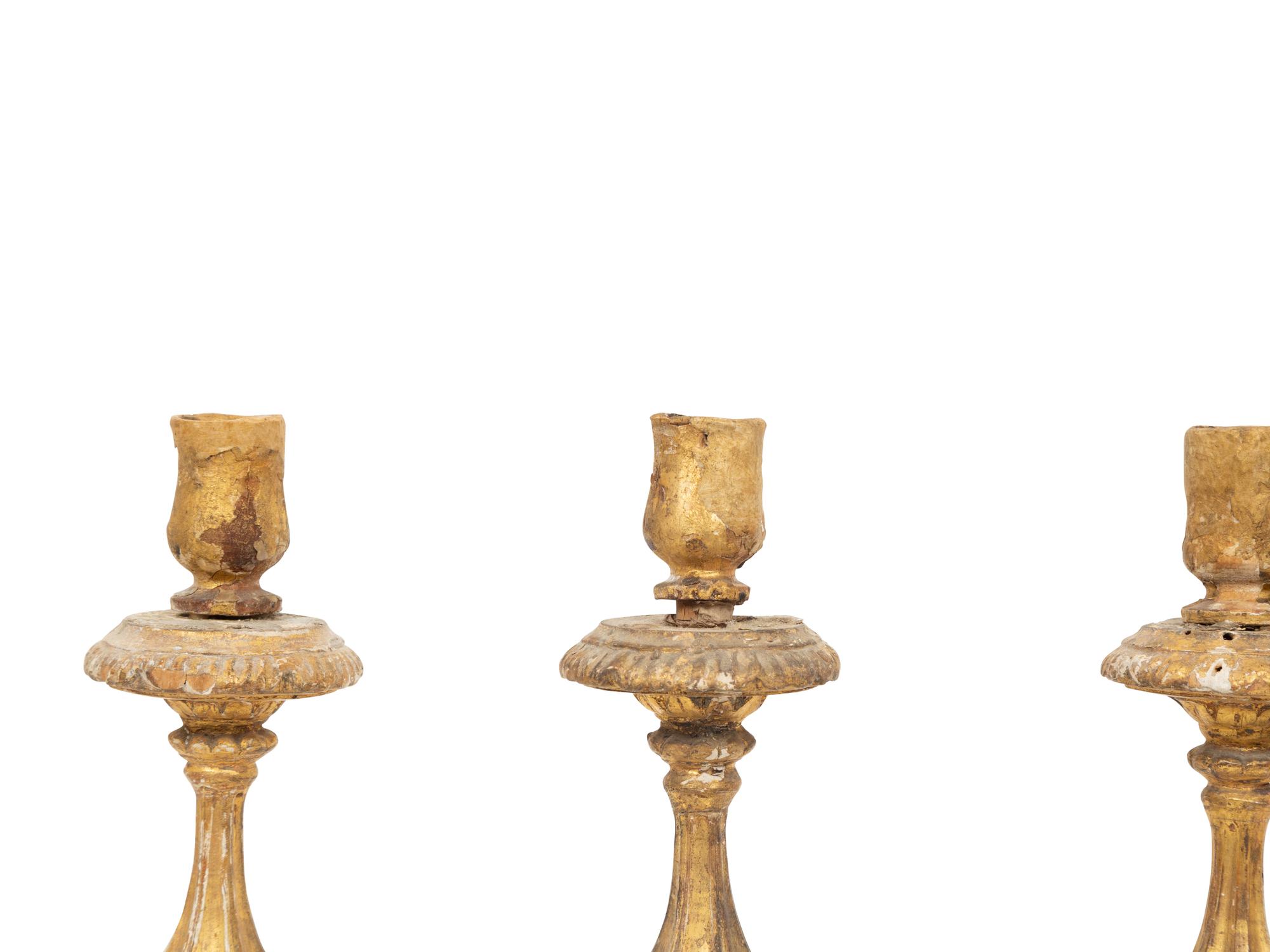 A Set of Four Italian Giltwood Candlesticks