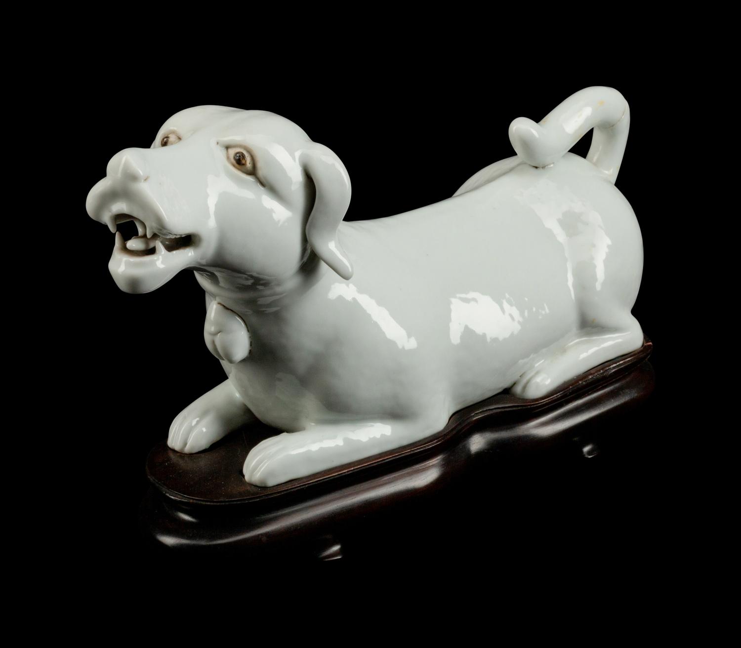 A Chinese Export Blanc de Chine Porcelain Figure of a Recumbent Dog — 19TH CENTURY