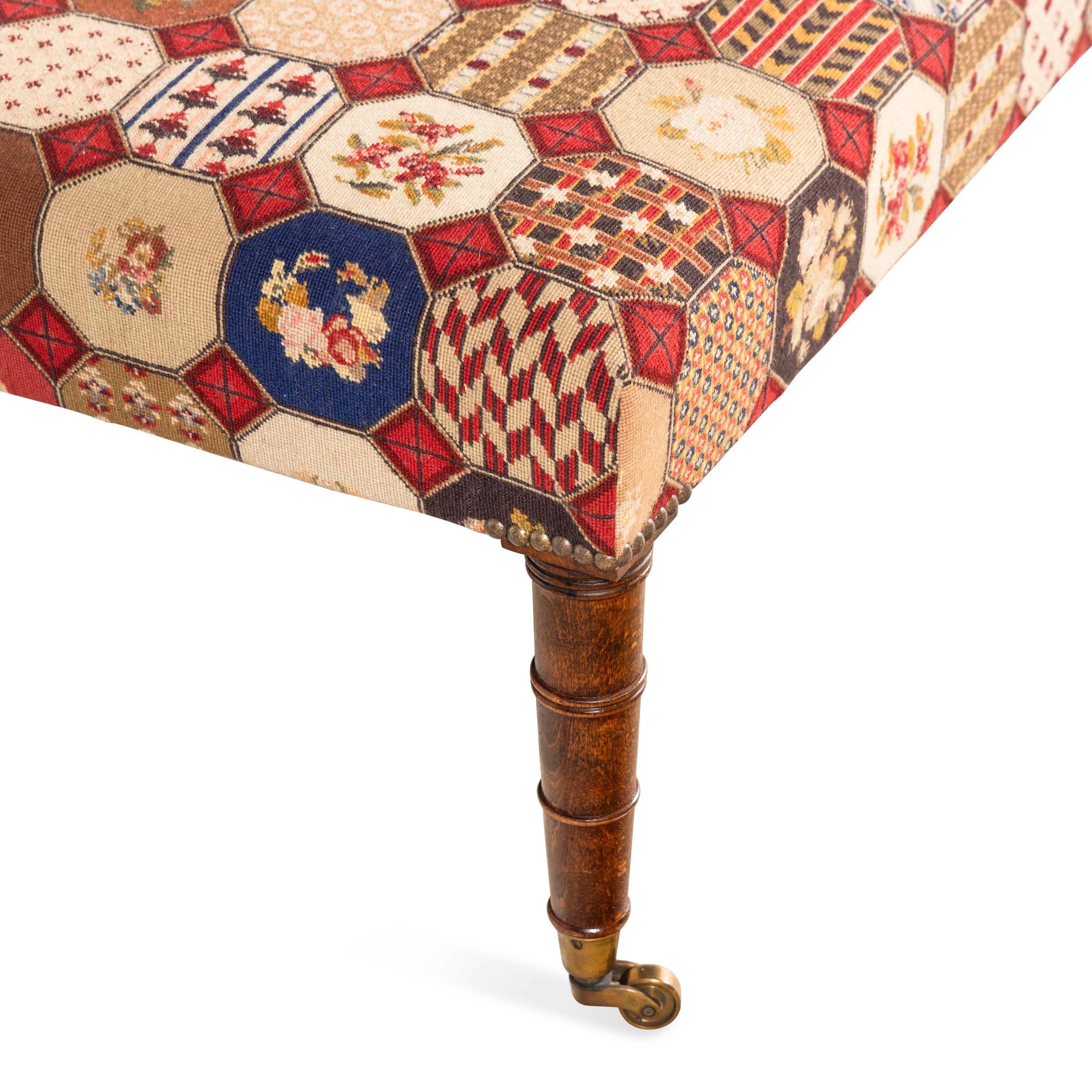 An English Mahogany and Needlepoint Upholstered Ottoman