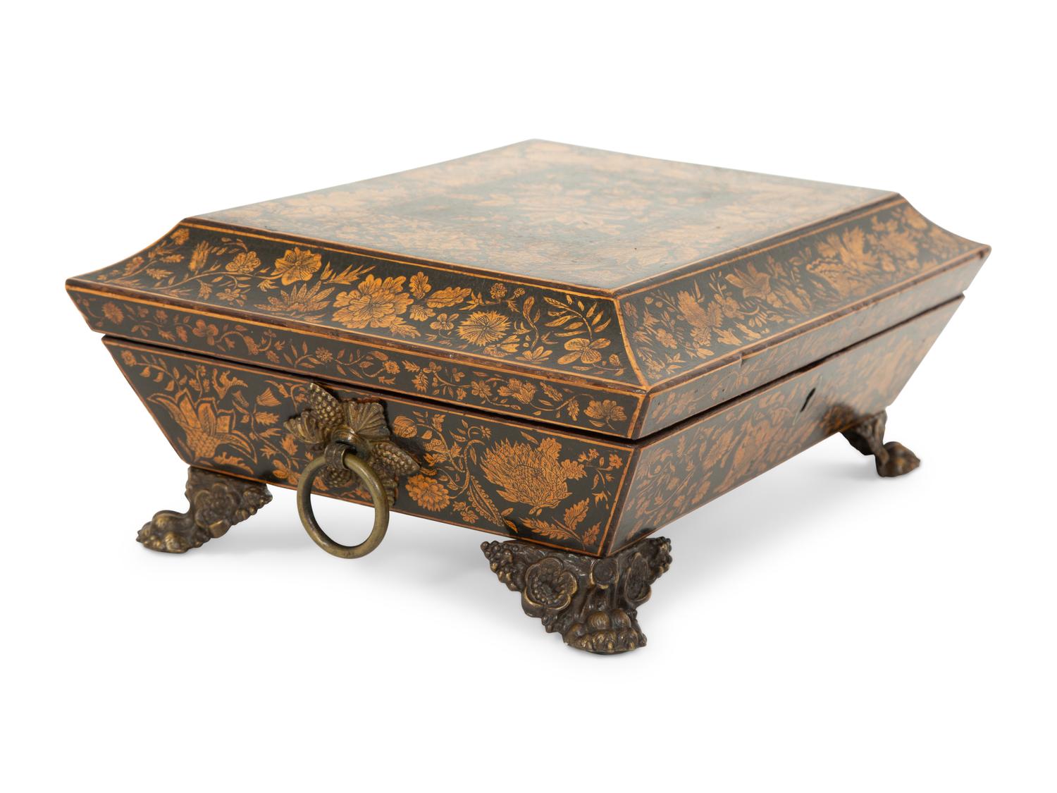 A Regency Black and Gilt Lacquer Box on Brass Paw Feet