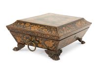 A Regency Black and Gilt Lacquer Box on Brass Paw Feet