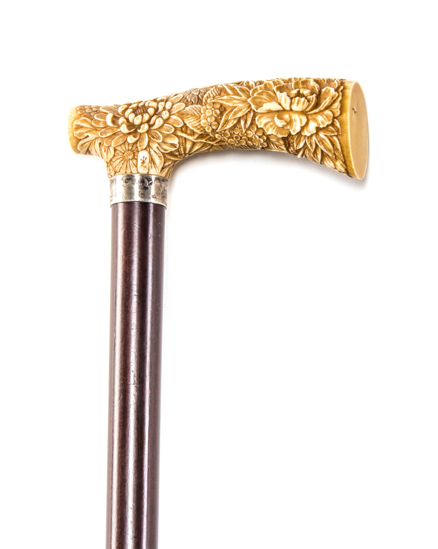 A Japanese Ivory Handled Cane, Length of handle 4 1/8 x length overall 33 3/4 inches.