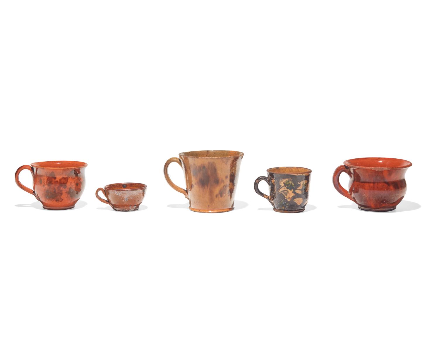A Group of Five Glazed Redware Mugs and Porringers, Pennsylvania, 19th Century