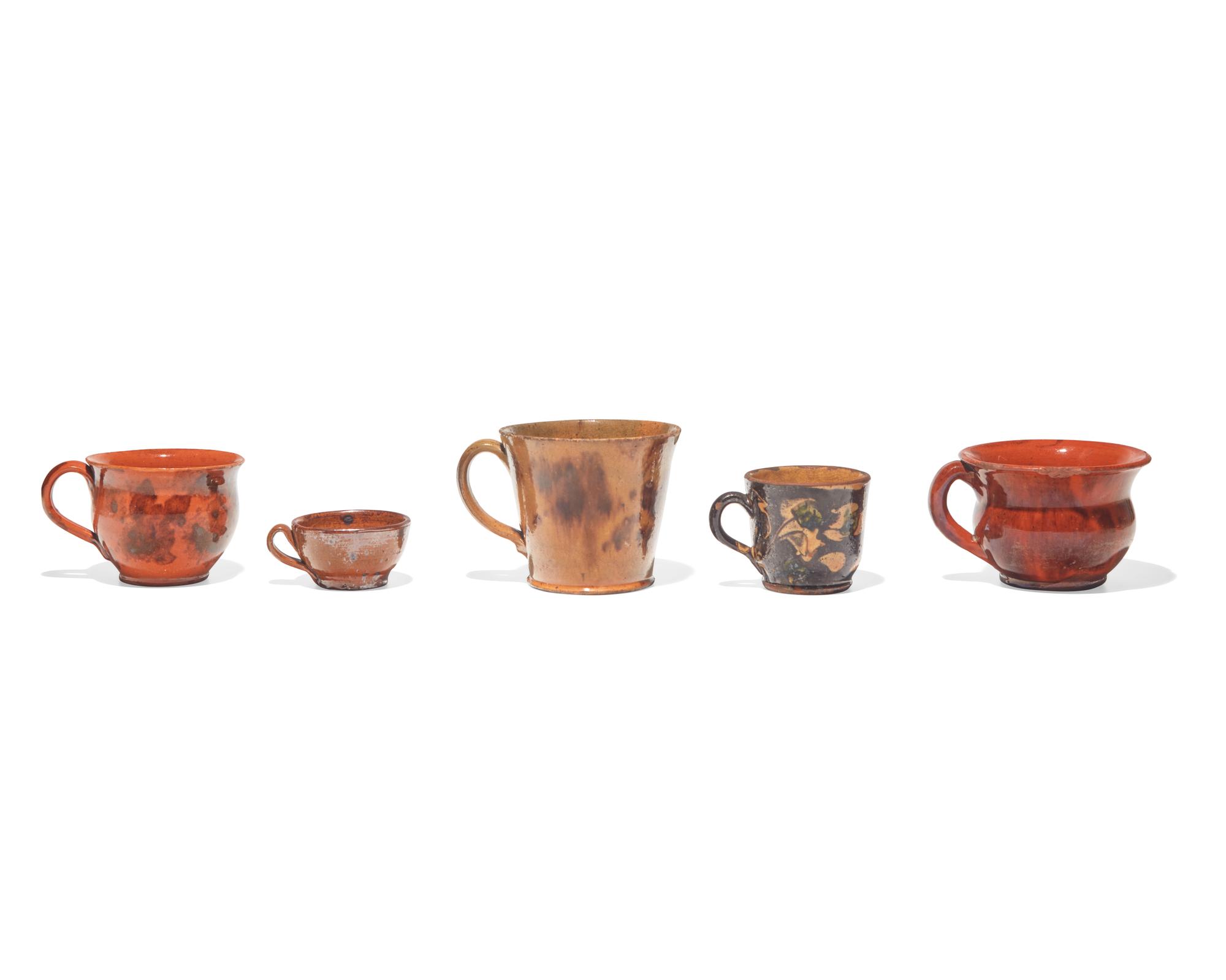 A Group of Five Glazed Redware Mugs and Porringers, Pennsylvania, 19th Century