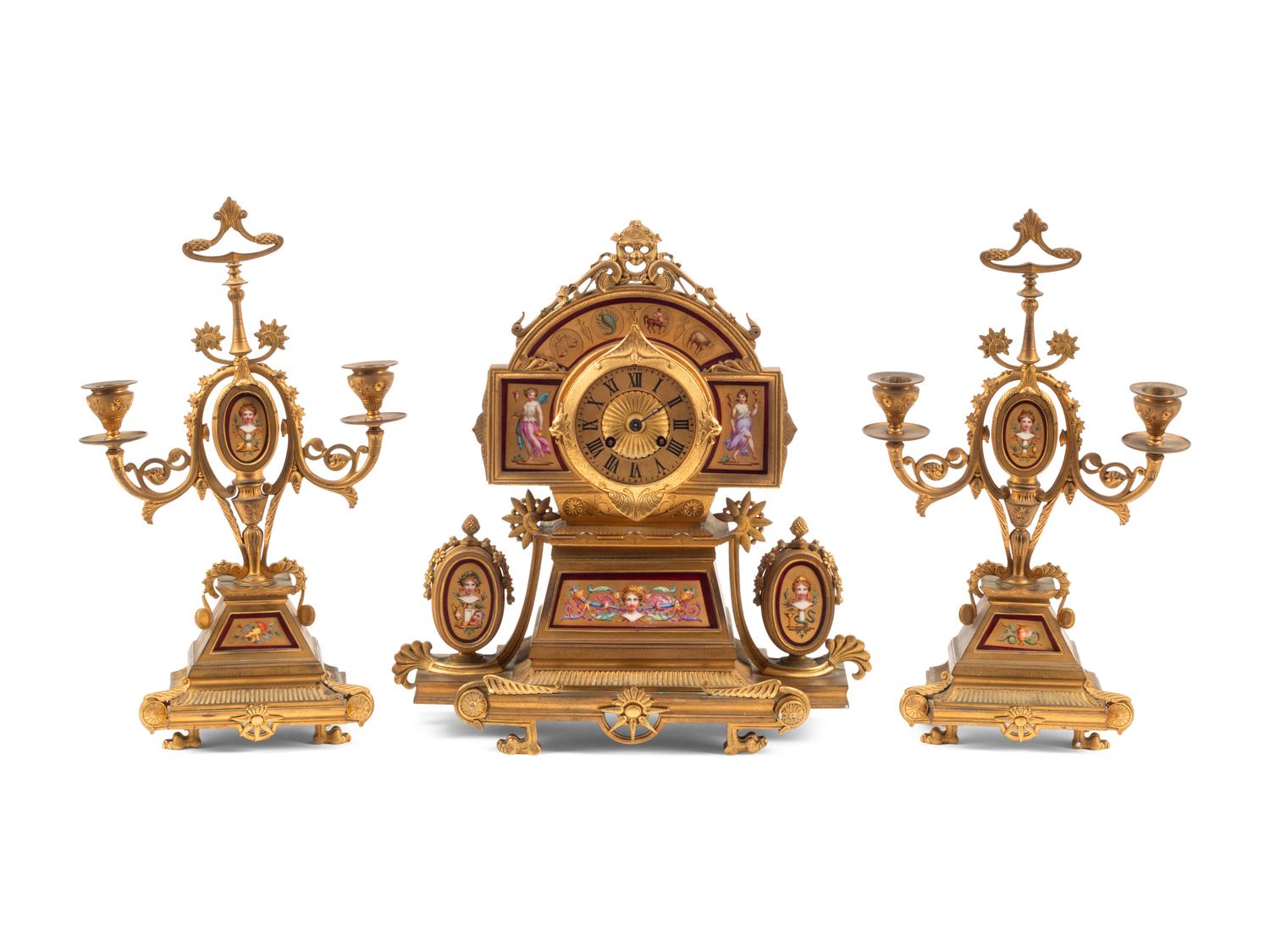 A French Neoclassical Gilt Bronze and Porcelain Plaque-Inset Clock Garniture