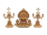 A French Neoclassical Gilt Bronze and Porcelain Plaque-Inset Clock Garniture