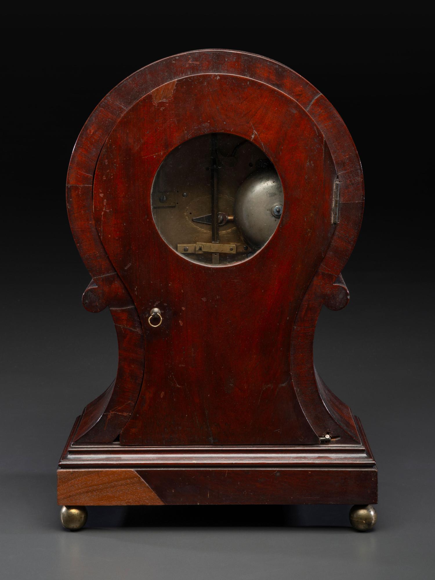 A Federal Carved and Figured Mahogany Balloon-Form Bracket Clock