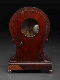 A Federal Carved and Figured Mahogany Balloon-Form Bracket Clock