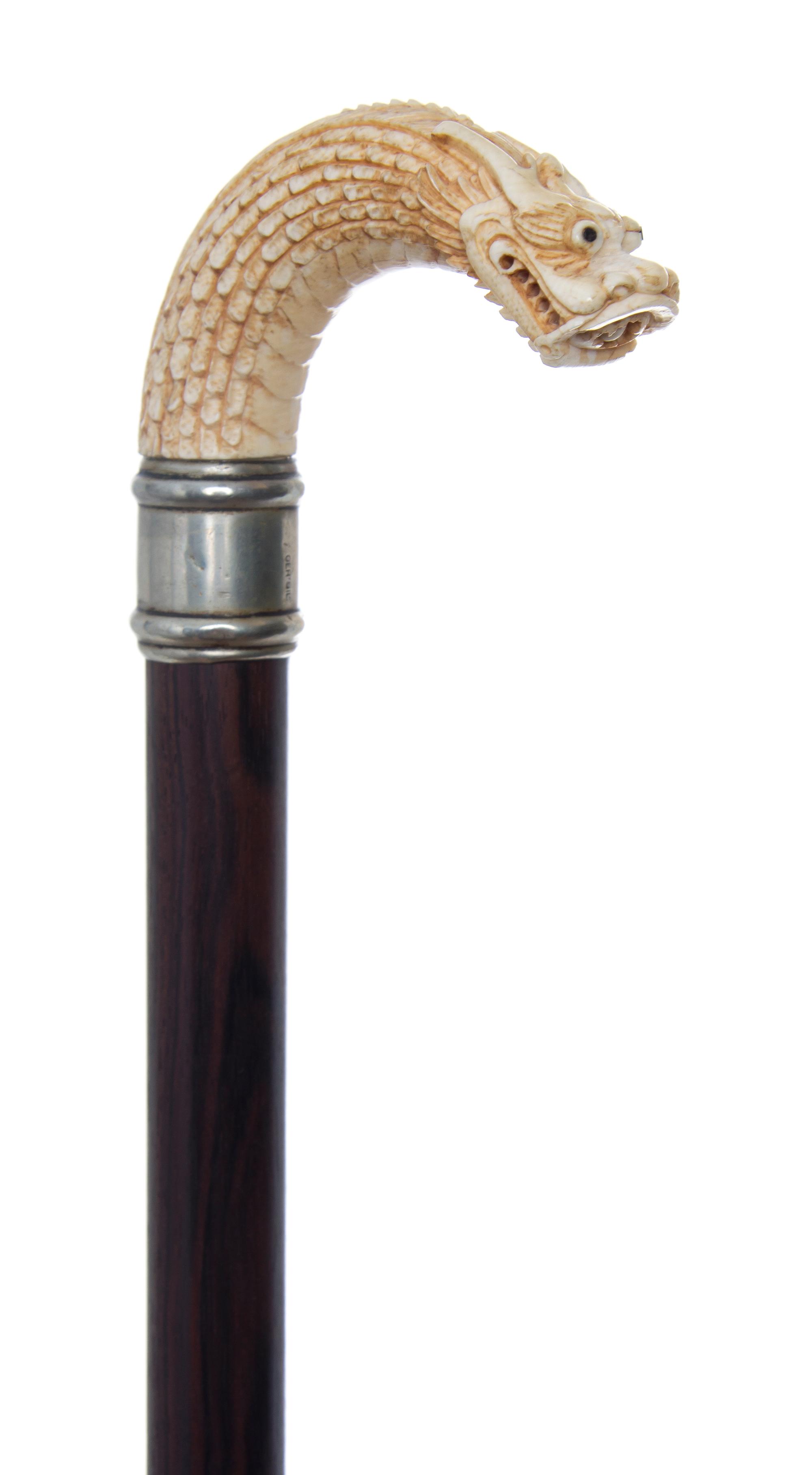 A Chinese Ivory Handled Cane, Length of handle 4 1/2 x length overall 35 inches.