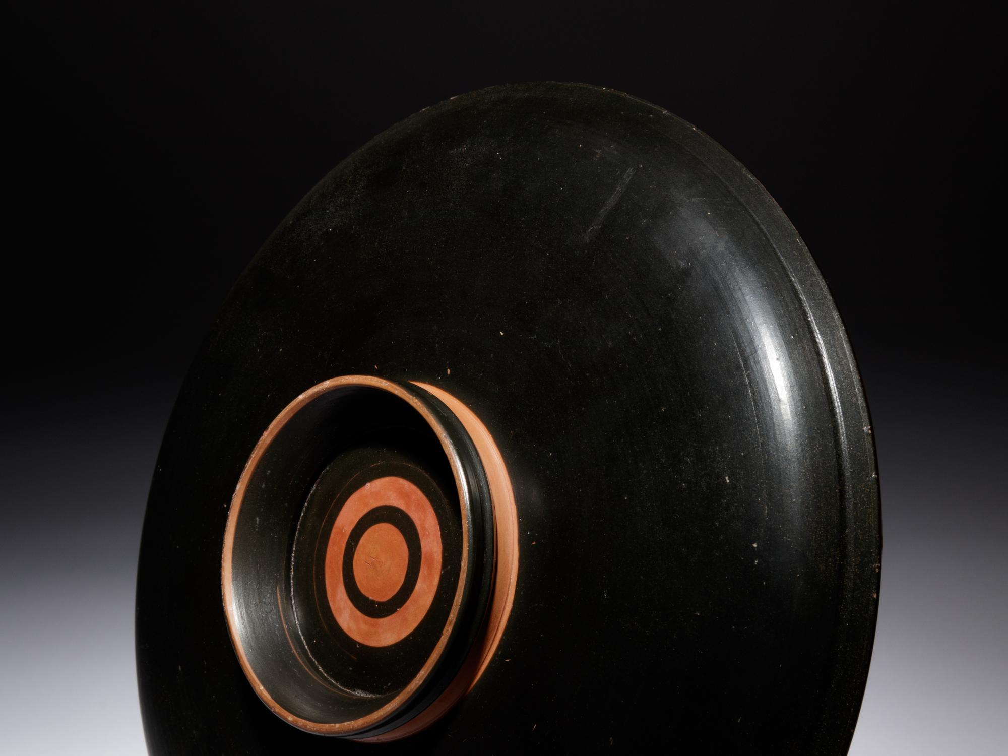 An Apulian Red-Figured Plate with Striding Eros