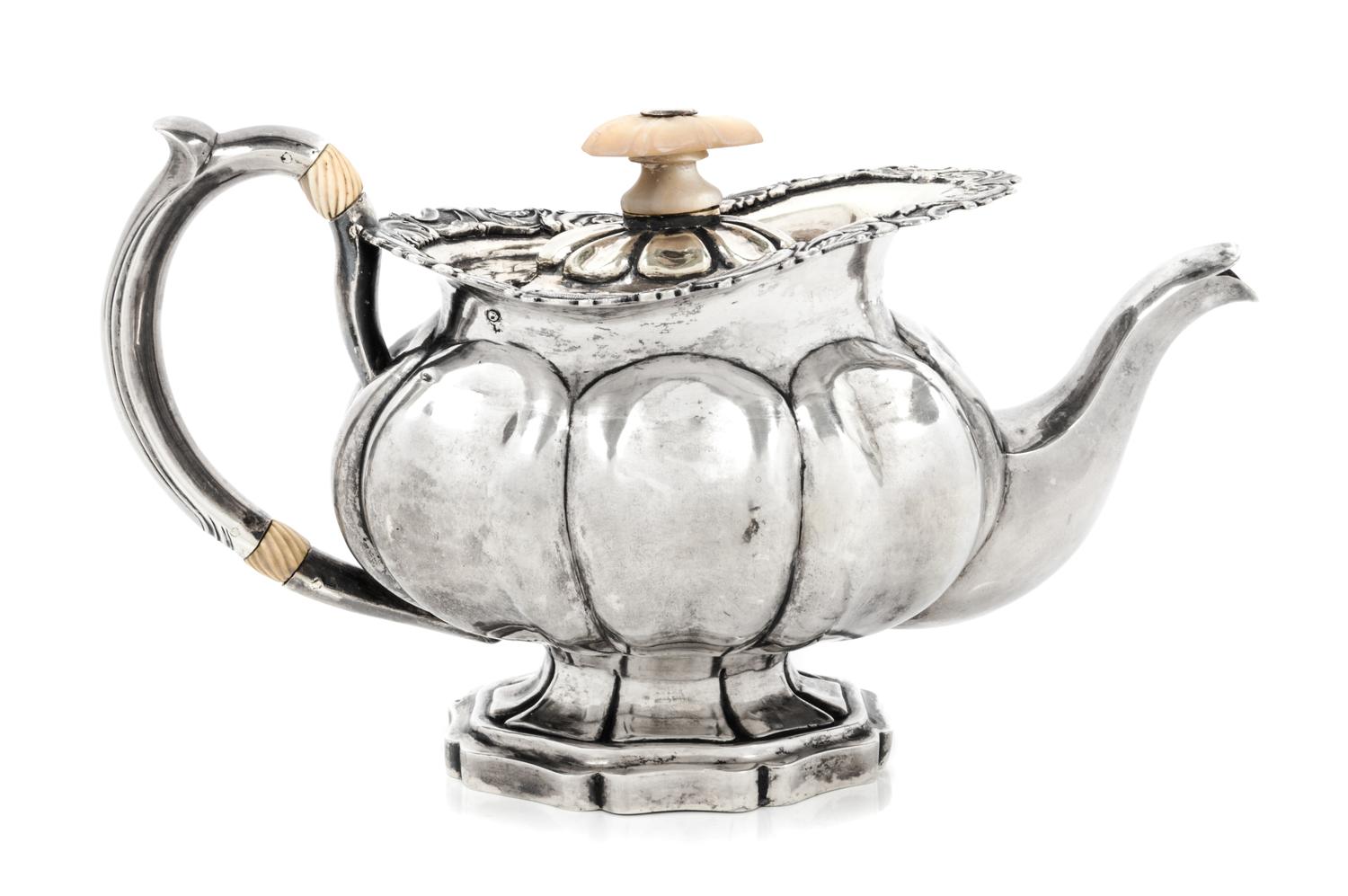 A Russian Silver Teapot, Maker's Mark I.R.S., St. Petersburg, 1839, having a mother-of-pearl finial above the rim worked to show volute