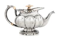 A Russian Silver Teapot, Maker's Mark I.R.S., St. Petersburg, 1839, having a mother-of-pearl finial above the rim worked to show volute