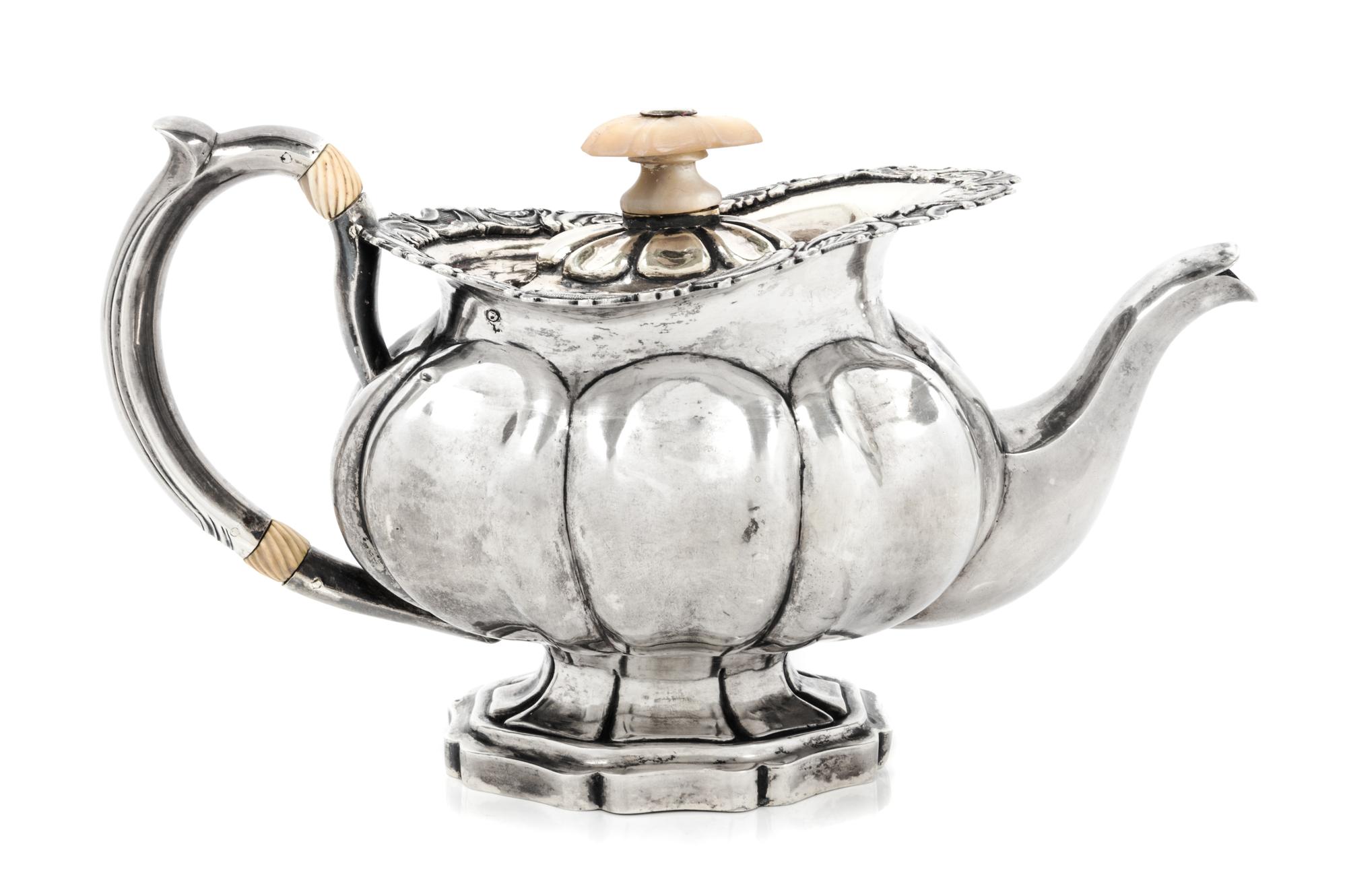 A Russian Silver Teapot, Maker's Mark I.R.S., St. Petersburg, 1839, having a mother-of-pearl finial above the rim worked to show volute
