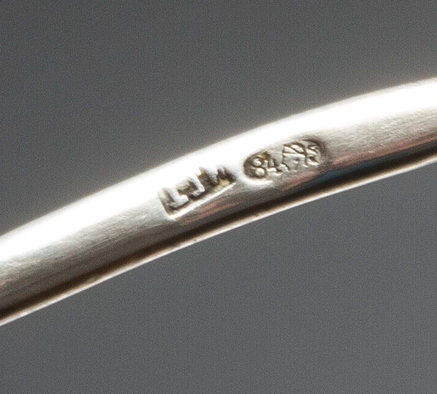 A Russian Enameled Silver Spoon, Maker's mark obscured, Moscow, the back of the circular bowl worked with flower heads against a textur