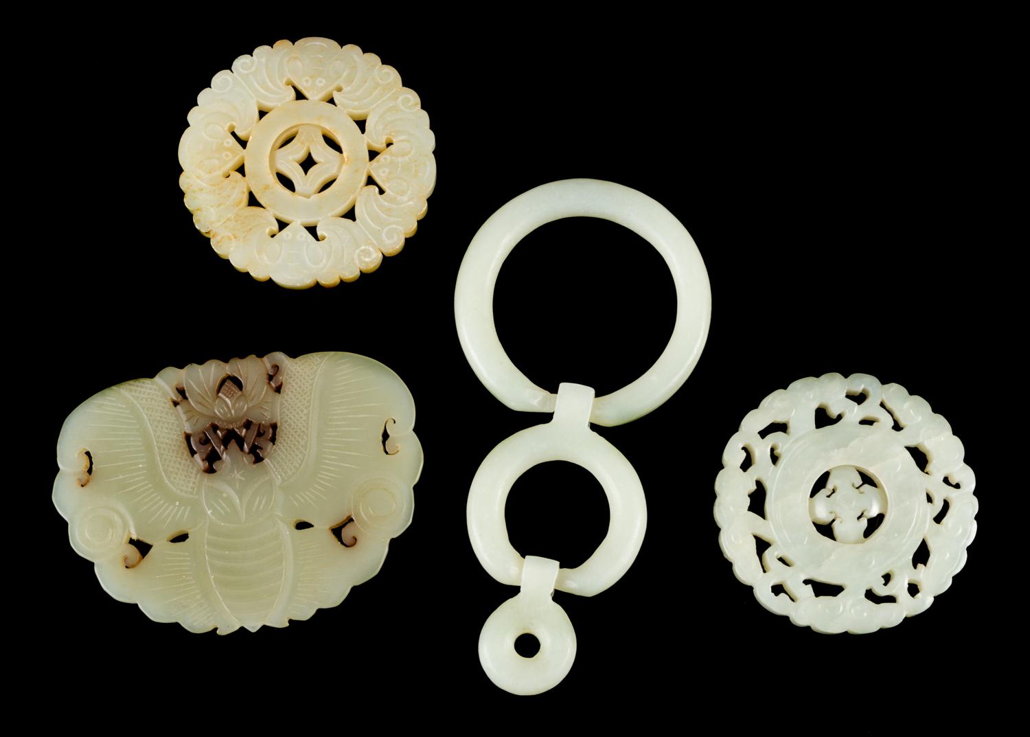 Four Celadon Jade Plaques Length of largest 3 1/8 inches.