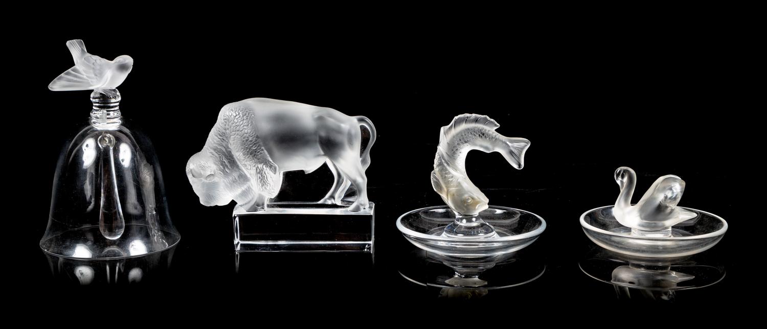 Lalique, a group of four molded and frosted glass articles, comprising a bell, two ring trays, and a figure of a buffalo