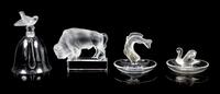 Lalique, a group of four molded and frosted glass articles, comprising a bell, two ring trays, and a figure of a buffalo
