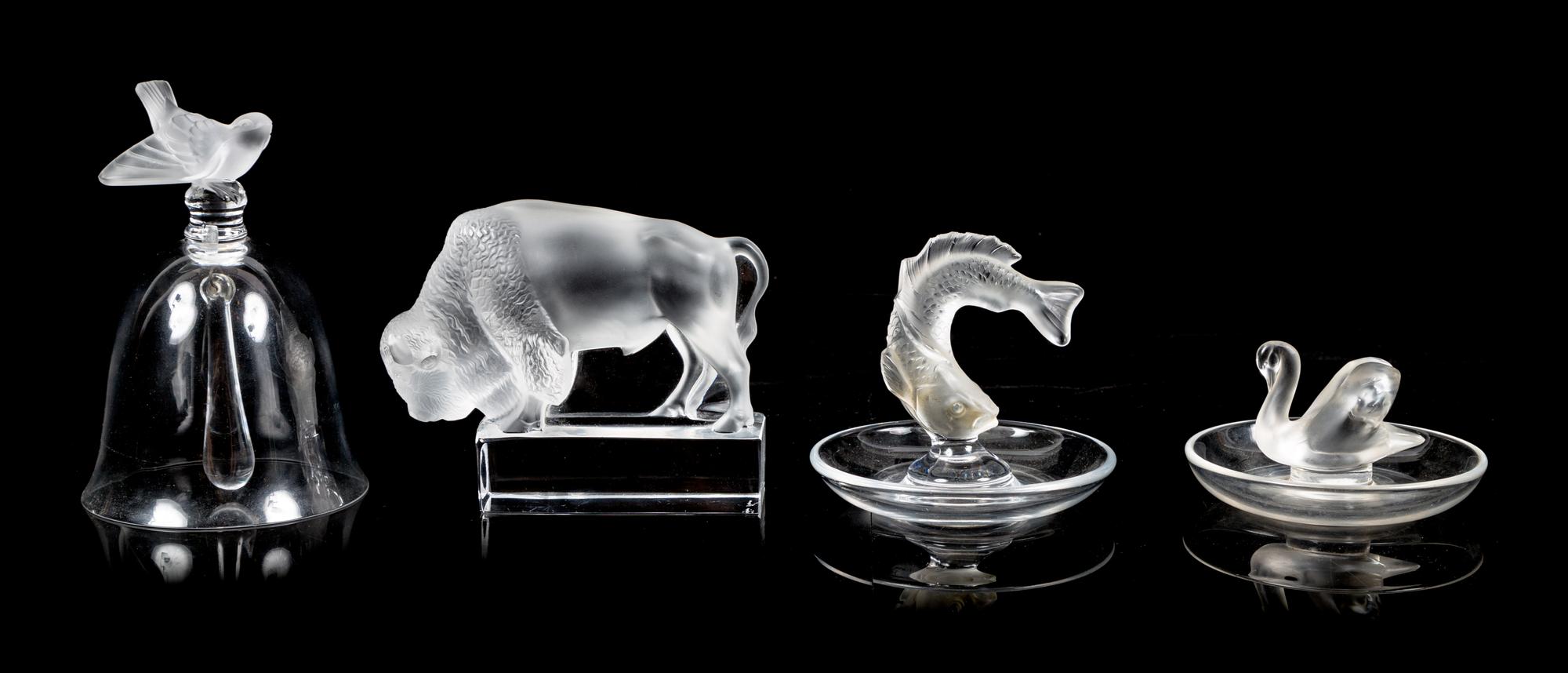 Lalique, a group of four molded and frosted glass articles, comprising a bell, two ring trays, and a figure of a buffalo