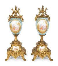 A Pair of Sèvres Style Porcelain Small Urns with Gilt Metal Mounts