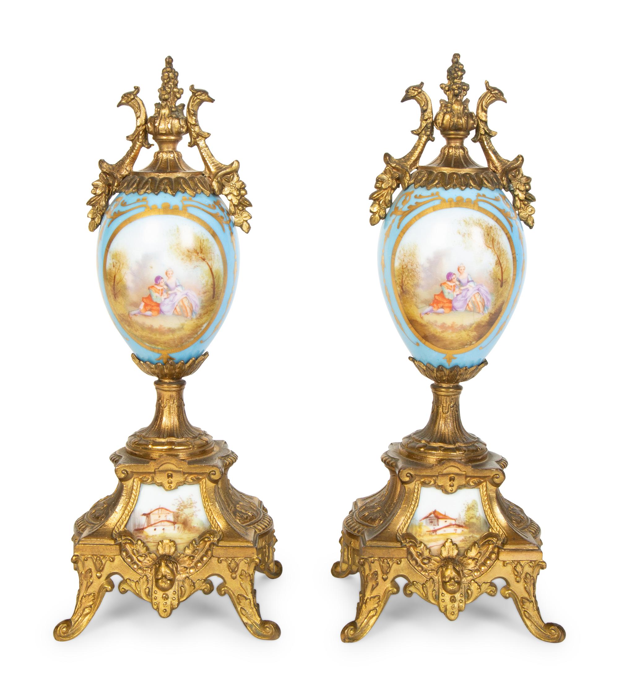 A Pair of Sèvres Style Porcelain Small Urns with Gilt Metal Mounts