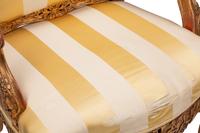 A Pair of Régence Style Giltwood Fauteuils