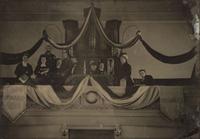 Ambrotypes Upward / Onward . Whole plate ambrotype of a musical group, likely a church band, posed in front of an organ. Ca 1876.