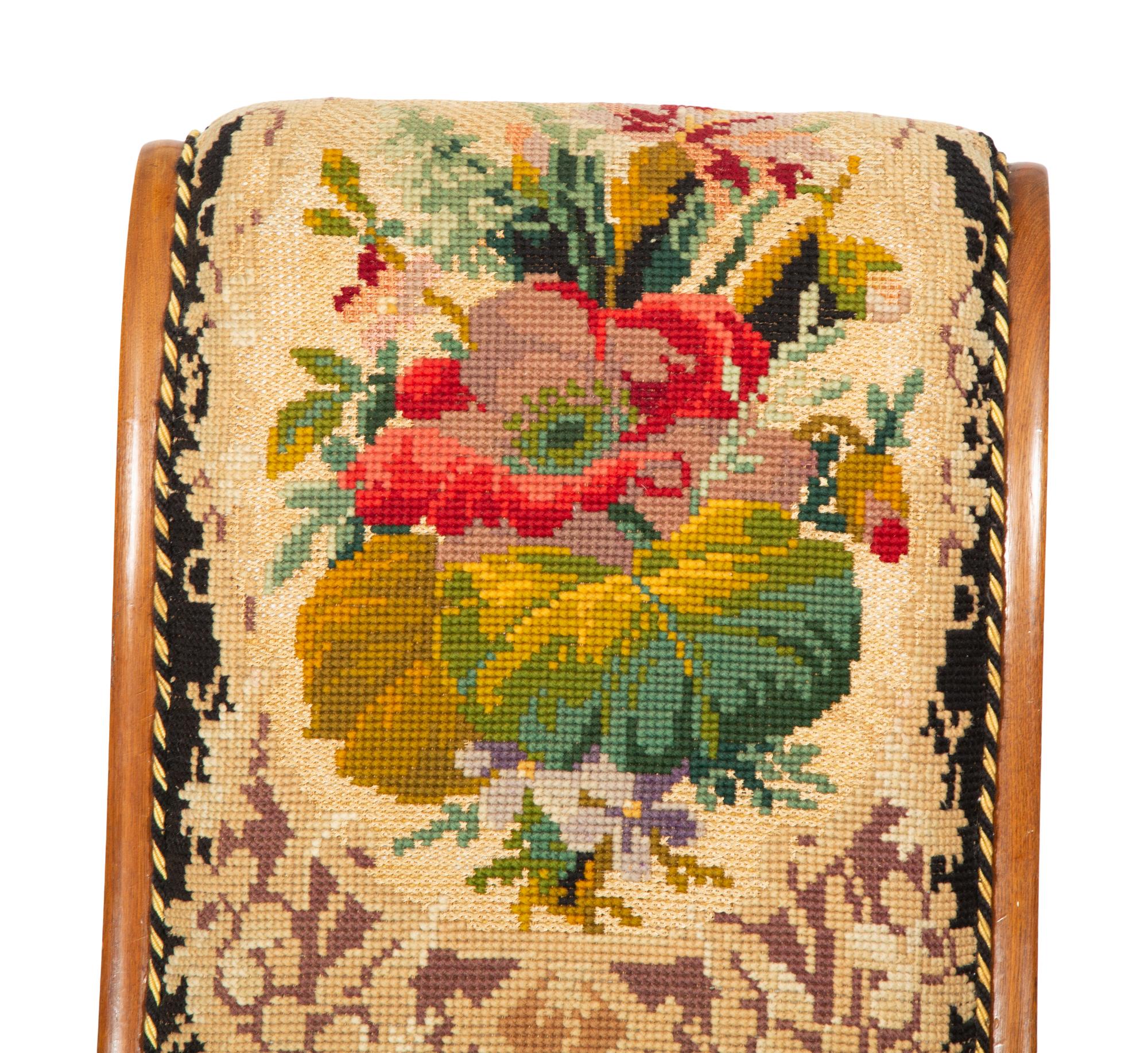 A Pair of Danish Walnut Slipper Chairs with Needlepoint Upholstery