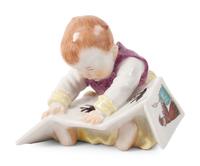 A Meissen Porcelain Baby Reading a Book, by Konrad Hentschel