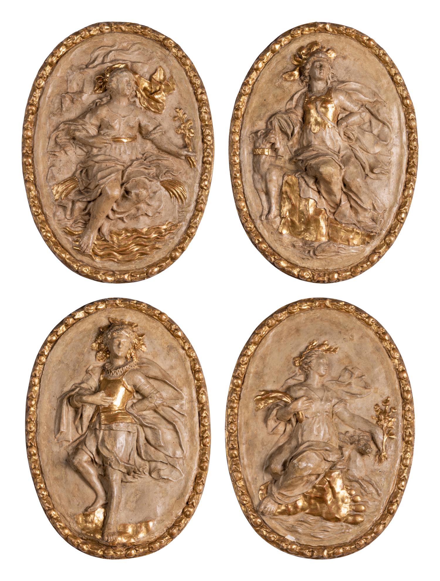 Four Italian Neoclassical Painted and Parcel-Gilt Papier-Mâché Relief Plaques
