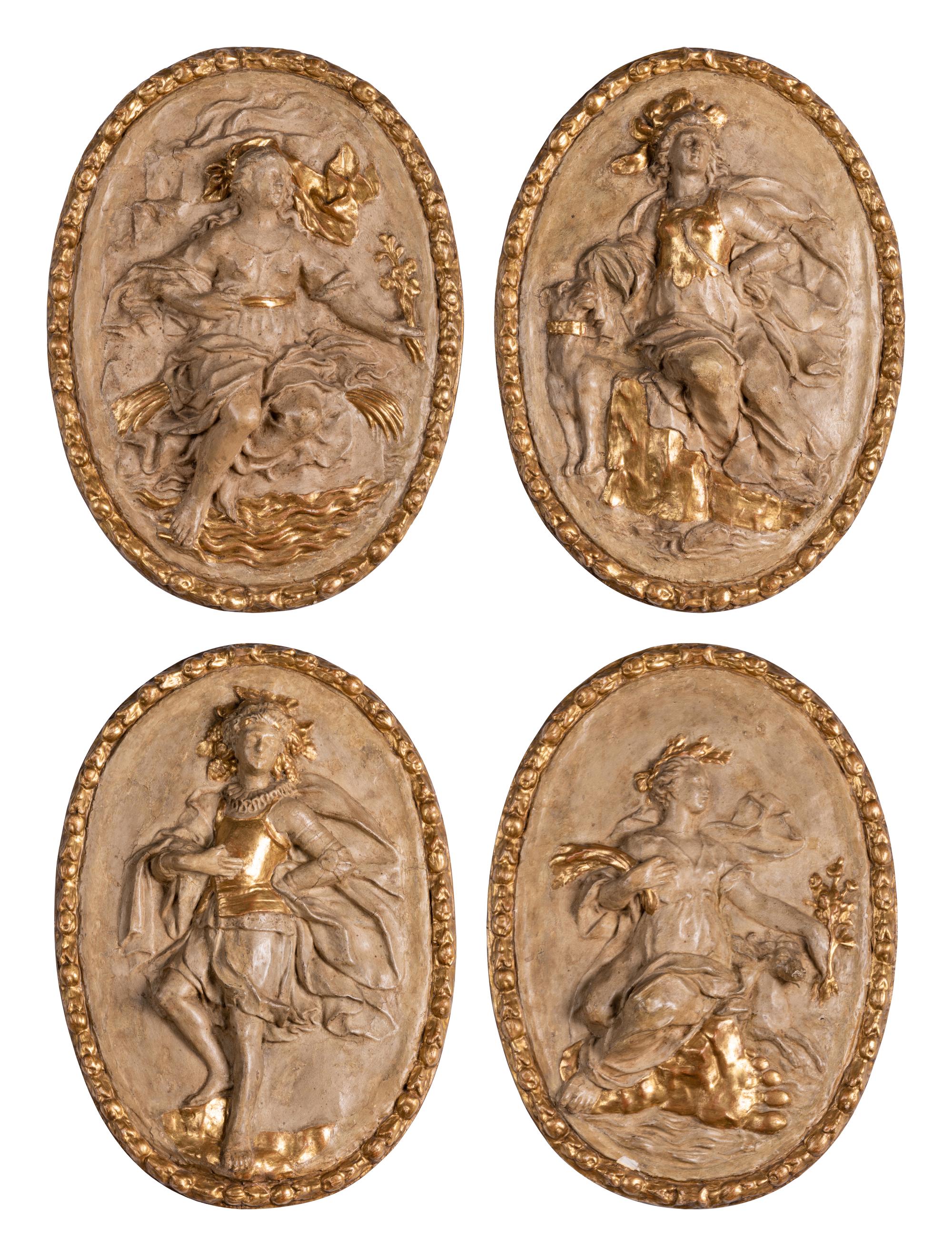 Four Italian Neoclassical Painted and Parcel-Gilt Papier-Mâché Relief Plaques