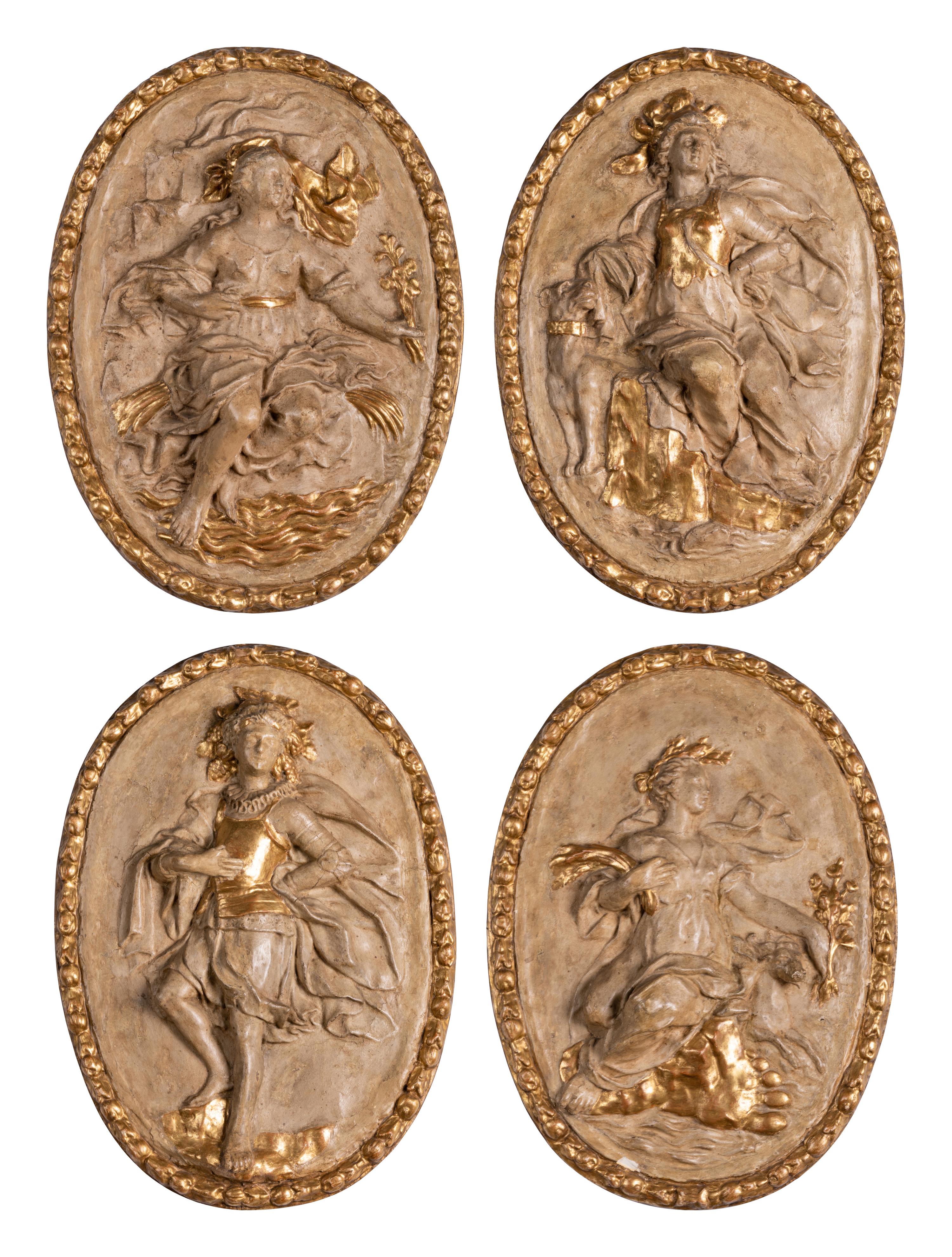 Four Italian Neoclassical Painted and Parcel-Gilt Papier-Mâché Relief Plaques