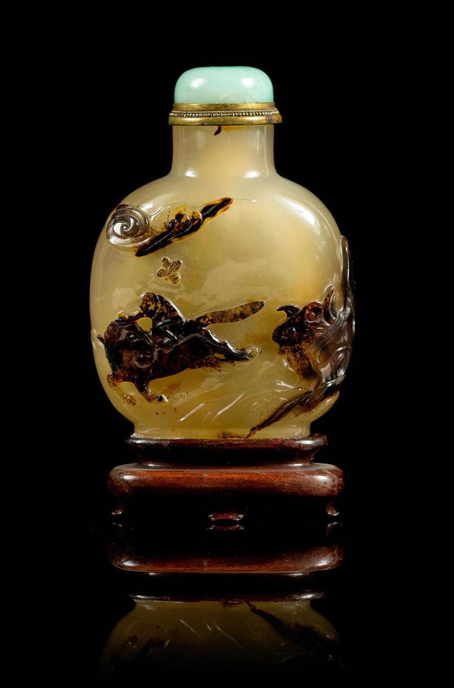 A Carved Agate Snuff Bottle Height 3 inches.