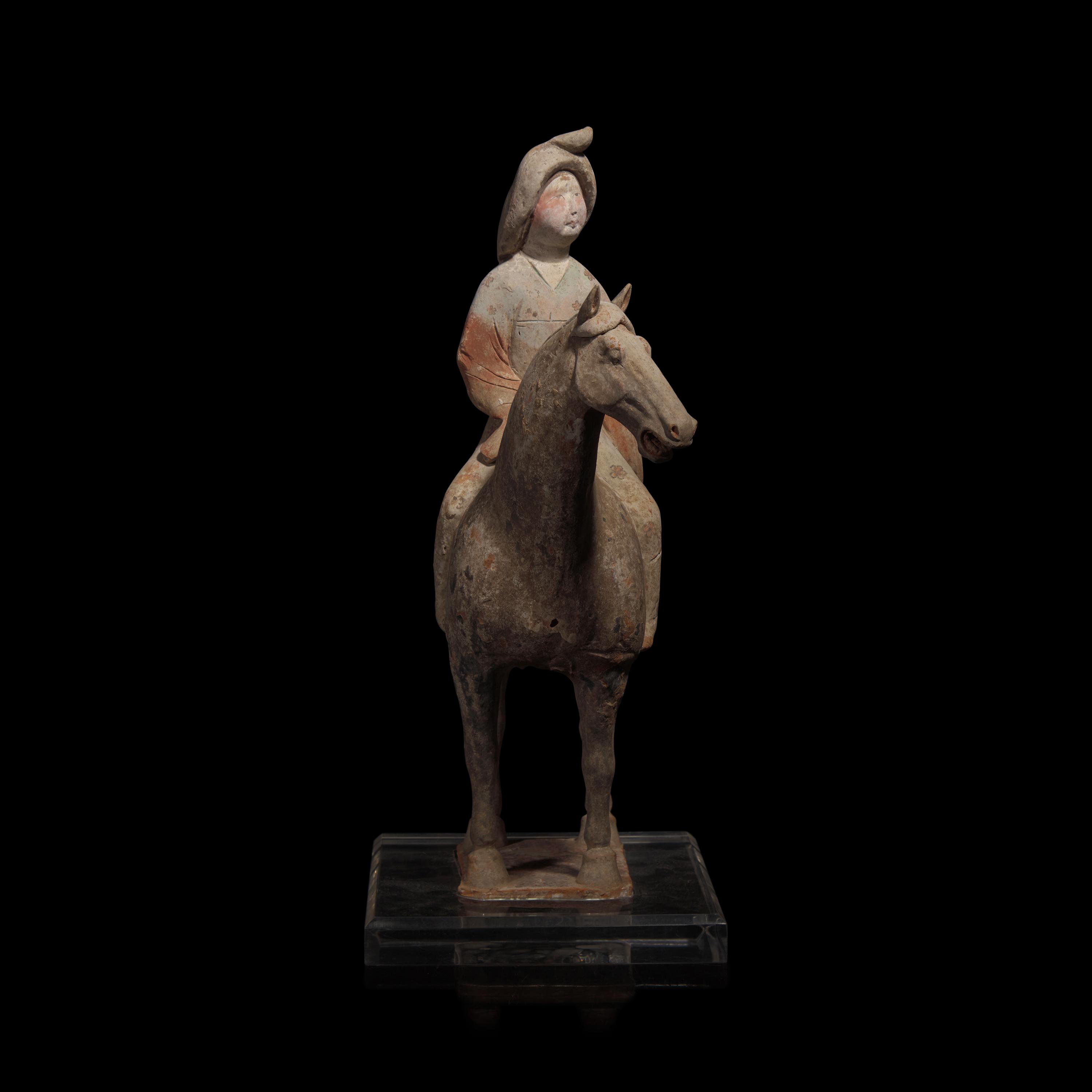 A Chinese Painted Pottery Female Equestrian Figure, Tang Dynasty — 唐 陶加彩女騎馬俑