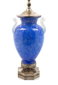 Steuben, FIRST HALF 20TH CENTURY, a blue Cluthra glass lamp, with opaline handles.