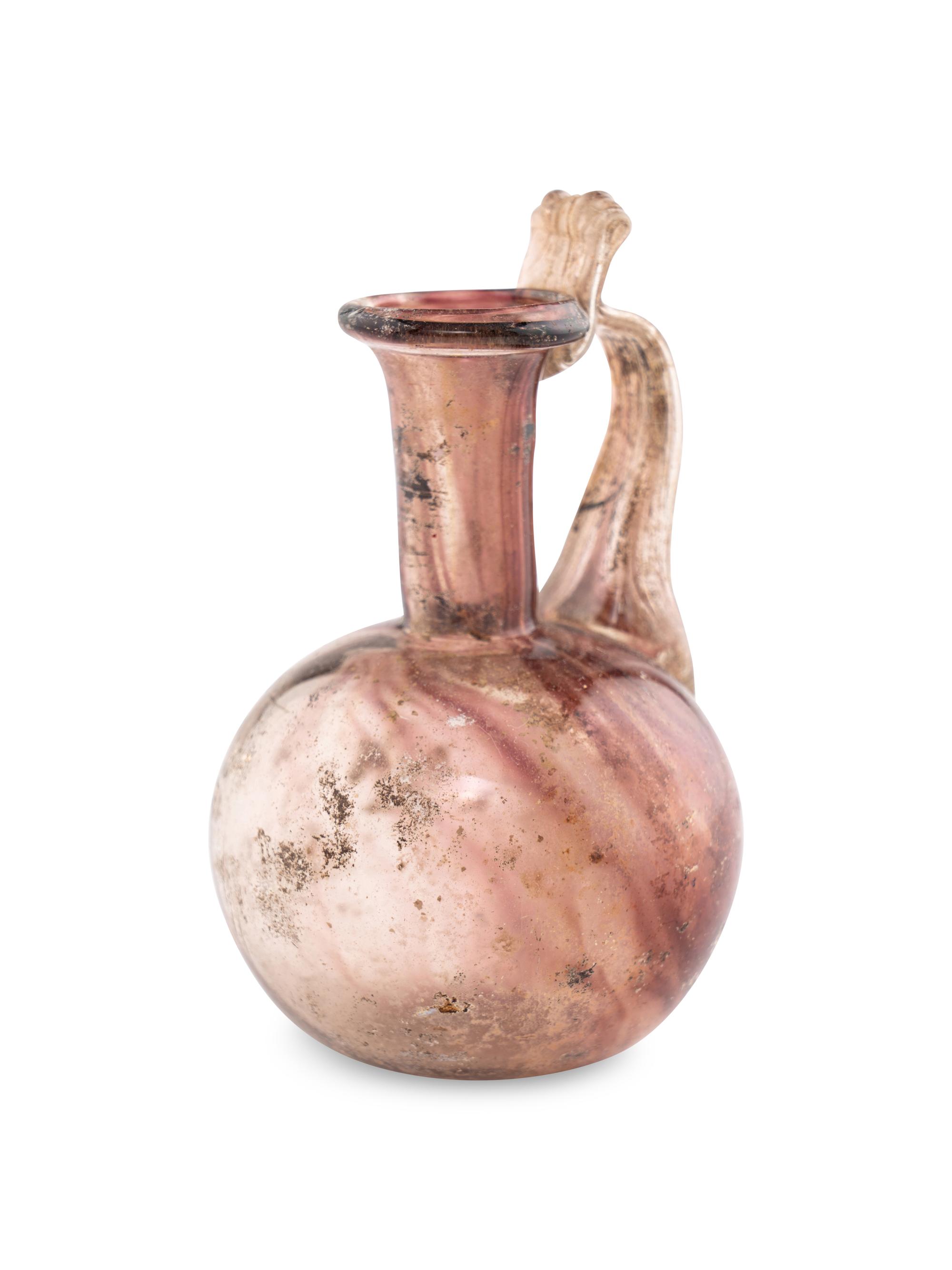 A Roman Glass Jug with Fluted Handle and Thumb Rest