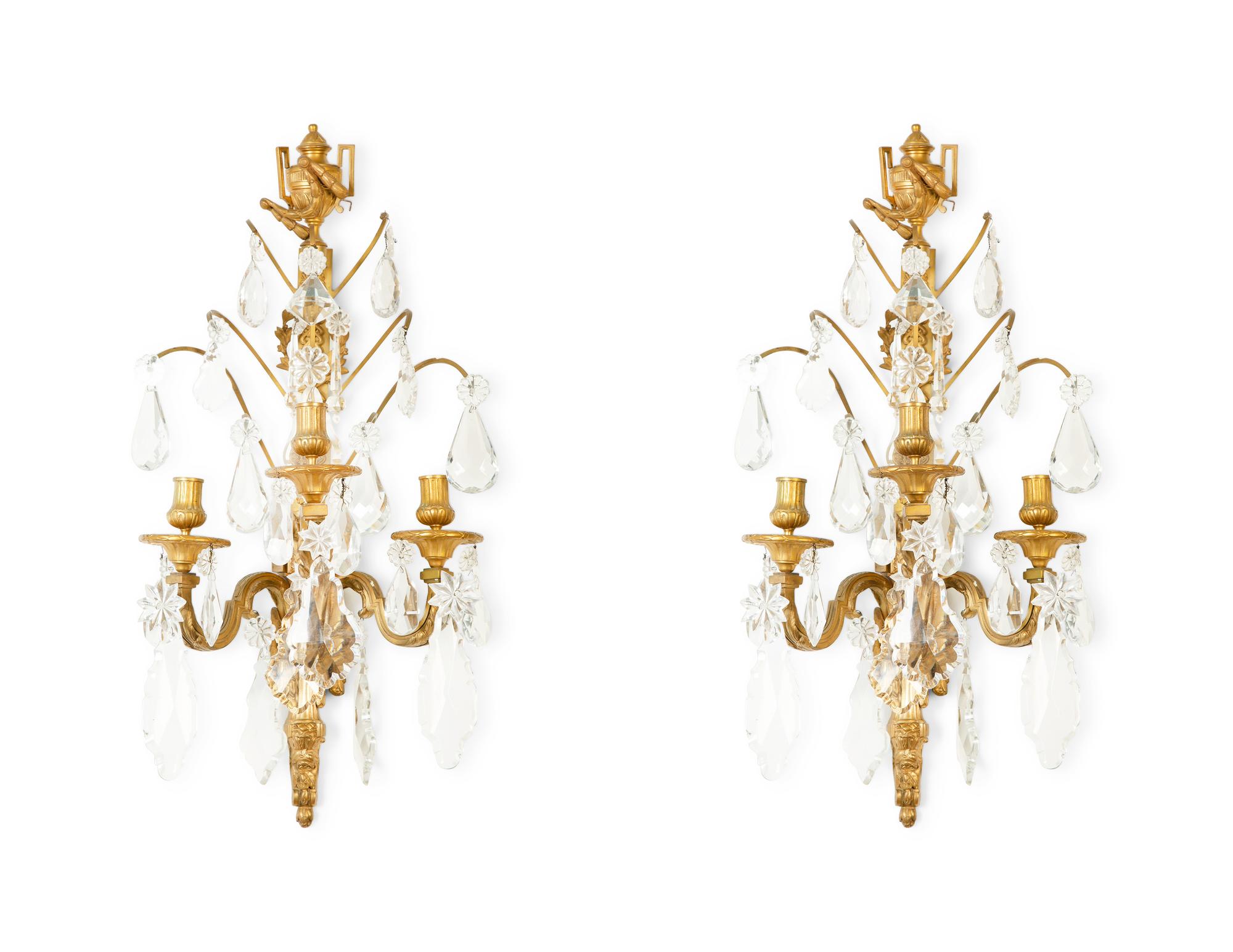 A Pair of Louis XVI Style Gilt Bronze and Cut Glass Three-Light Sconces