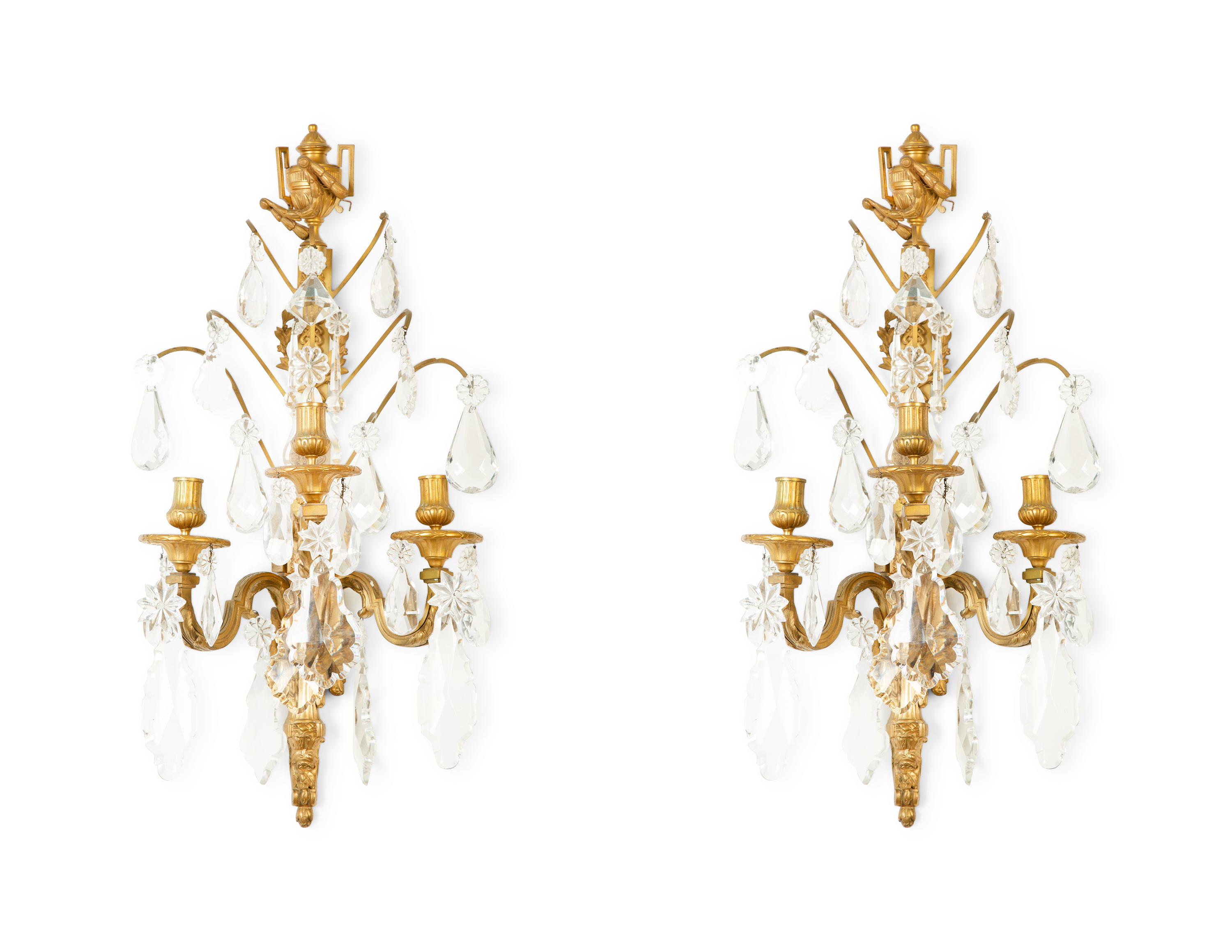 A Pair of Louis XVI Style Gilt Bronze and Cut Glass Three-Light Sconces