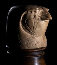 An Egyptian Limestone Canopic Jar Lid in the Form of Qebhsenuef
