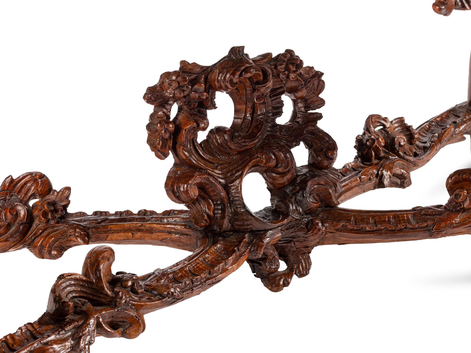 An Italian Rococo Carved Walnut Marble-Top Console Table