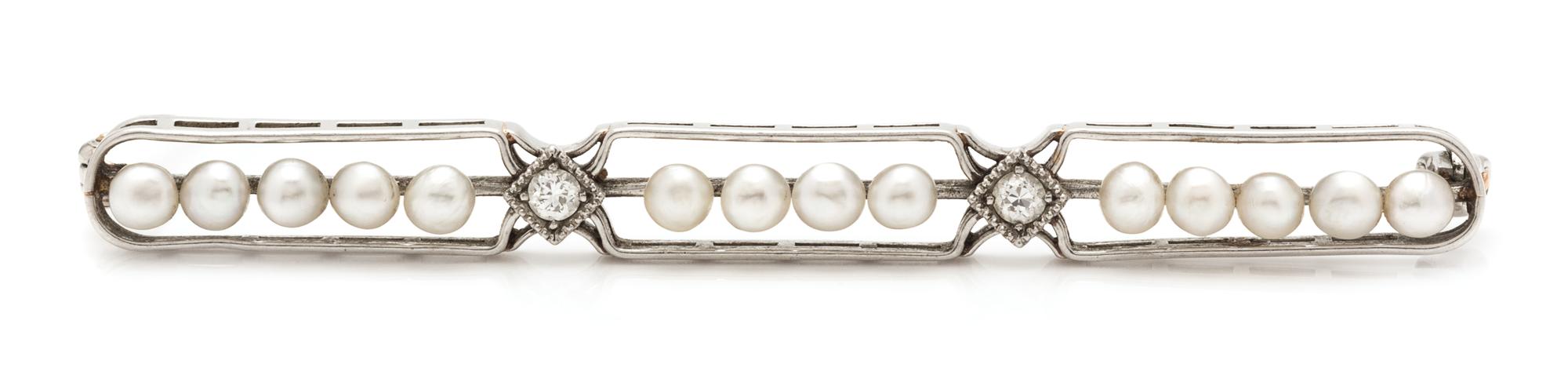 An Art Deco Platinum, Diamond and Seed Pearl Bar Brooch. 3.80 dwts.