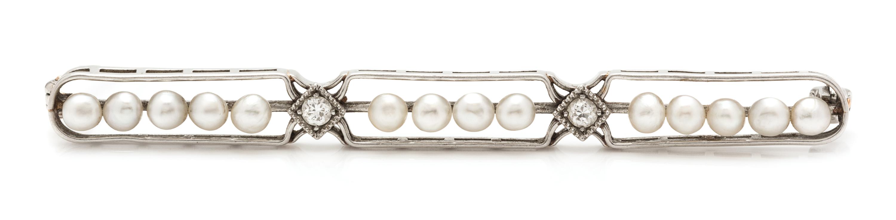 An Art Deco Platinum, Diamond and Seed Pearl Bar Brooch. 3.80 dwts.