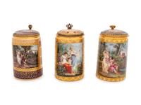 Three Vienna Painted and Parcel Gilt Porcelain Tankards