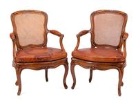 A Pair of Louis XV Beechwood Fauteuils with Cane and Leather Seat Cushions