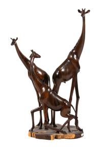 A Kenyan Carved Ebony Sculpture of Three Giraffes Height 38 inches. — 20TH CENTURY